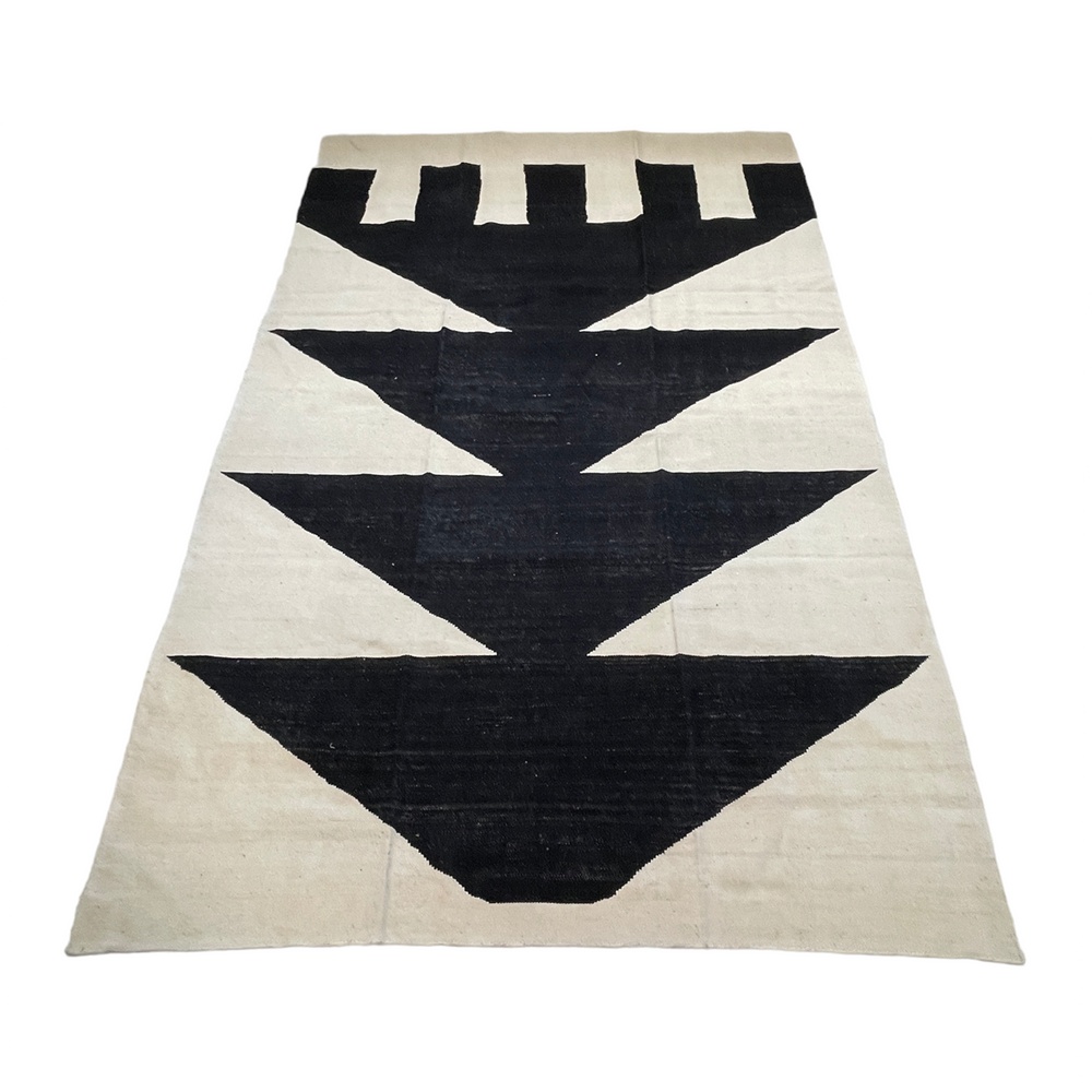 Cream area rug with black geometric design