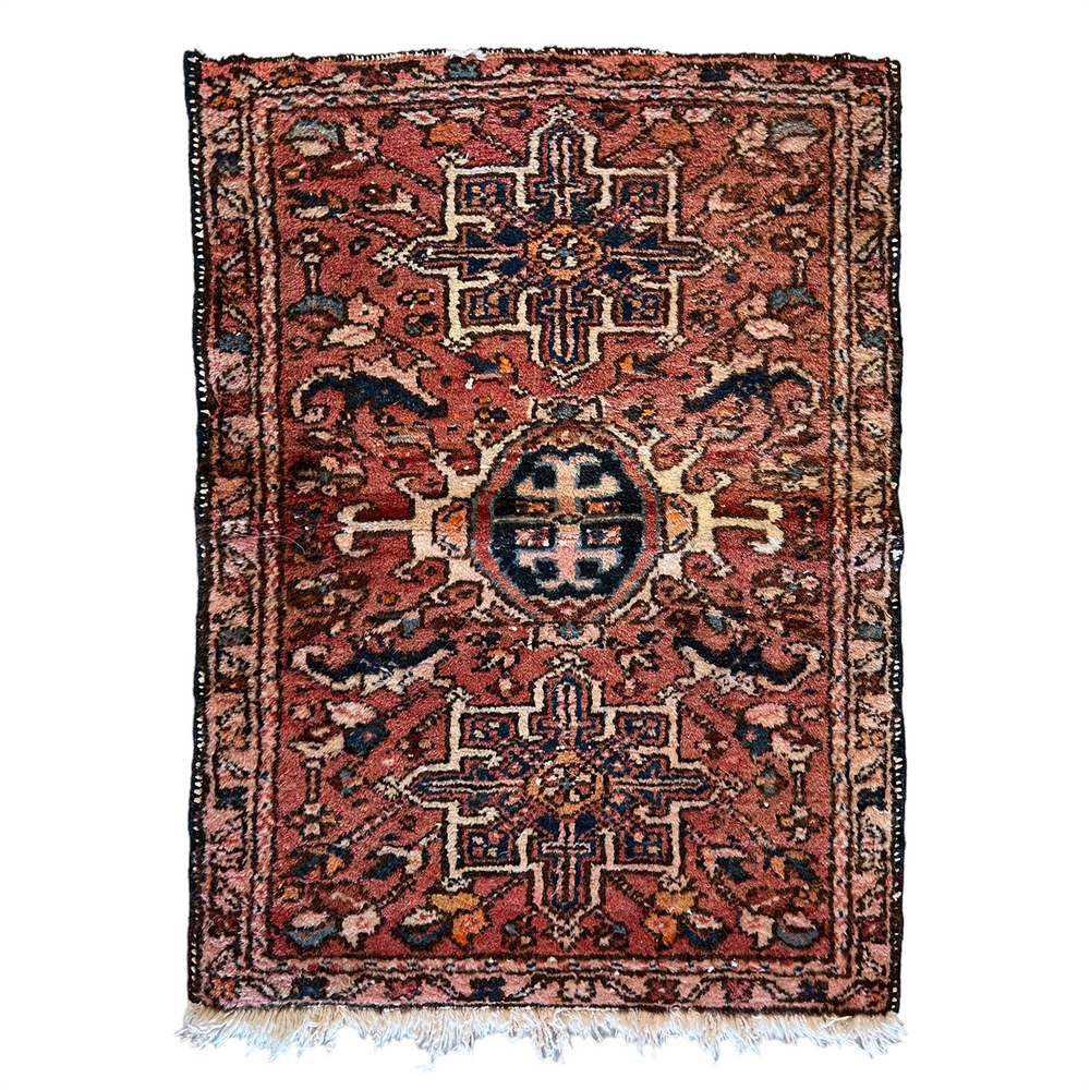 Vintage Persian accent rug with orange background and black, off white and orange details.
