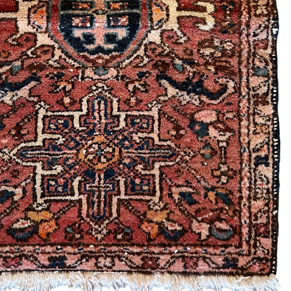 Vintage Persian accent rug with orange background and black, off white and orange details.