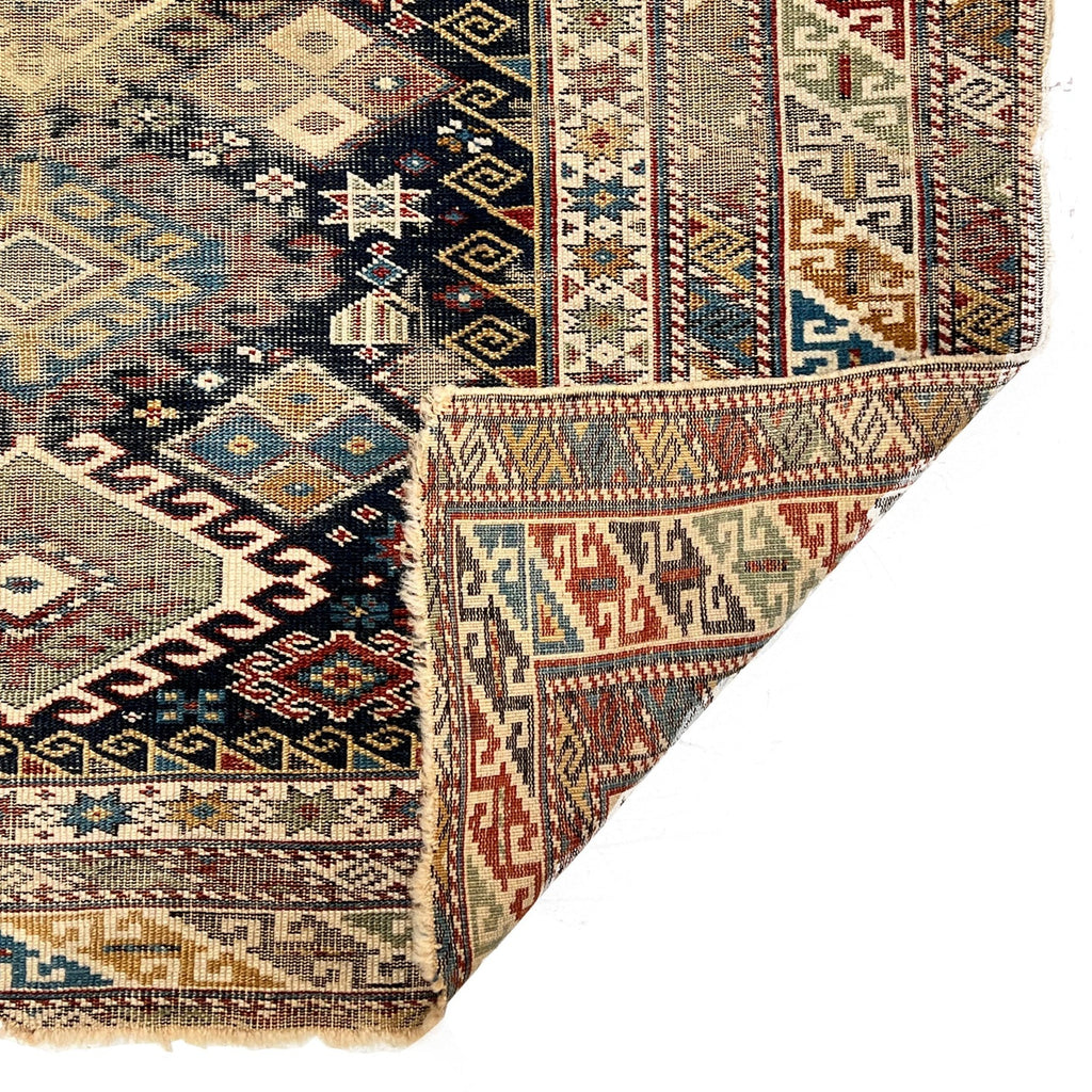 Vintage Tabriz accent rug with corner folded up to show flat weave