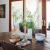 Table top styling inspiration with rustic reclaimed dining table, handmade ceramics and french doors