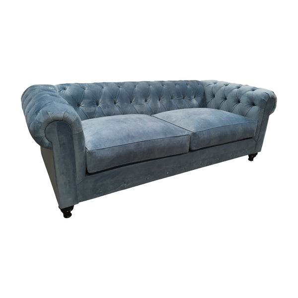 Blue velvet chesterfield with wood turned legs