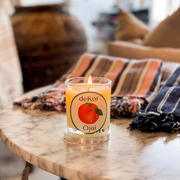 organic ojai candle on marble table with turkish towels