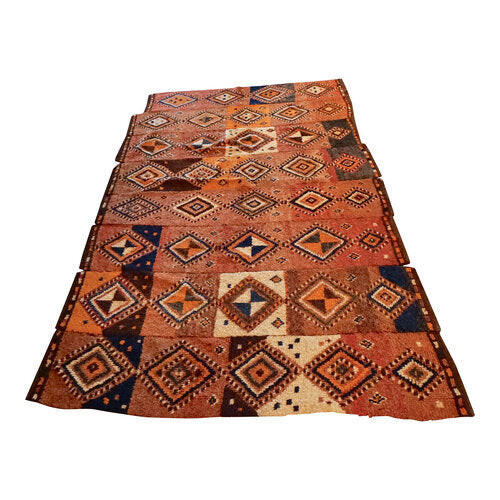 vintage moroccan area rug in tones of orange, off white and navy