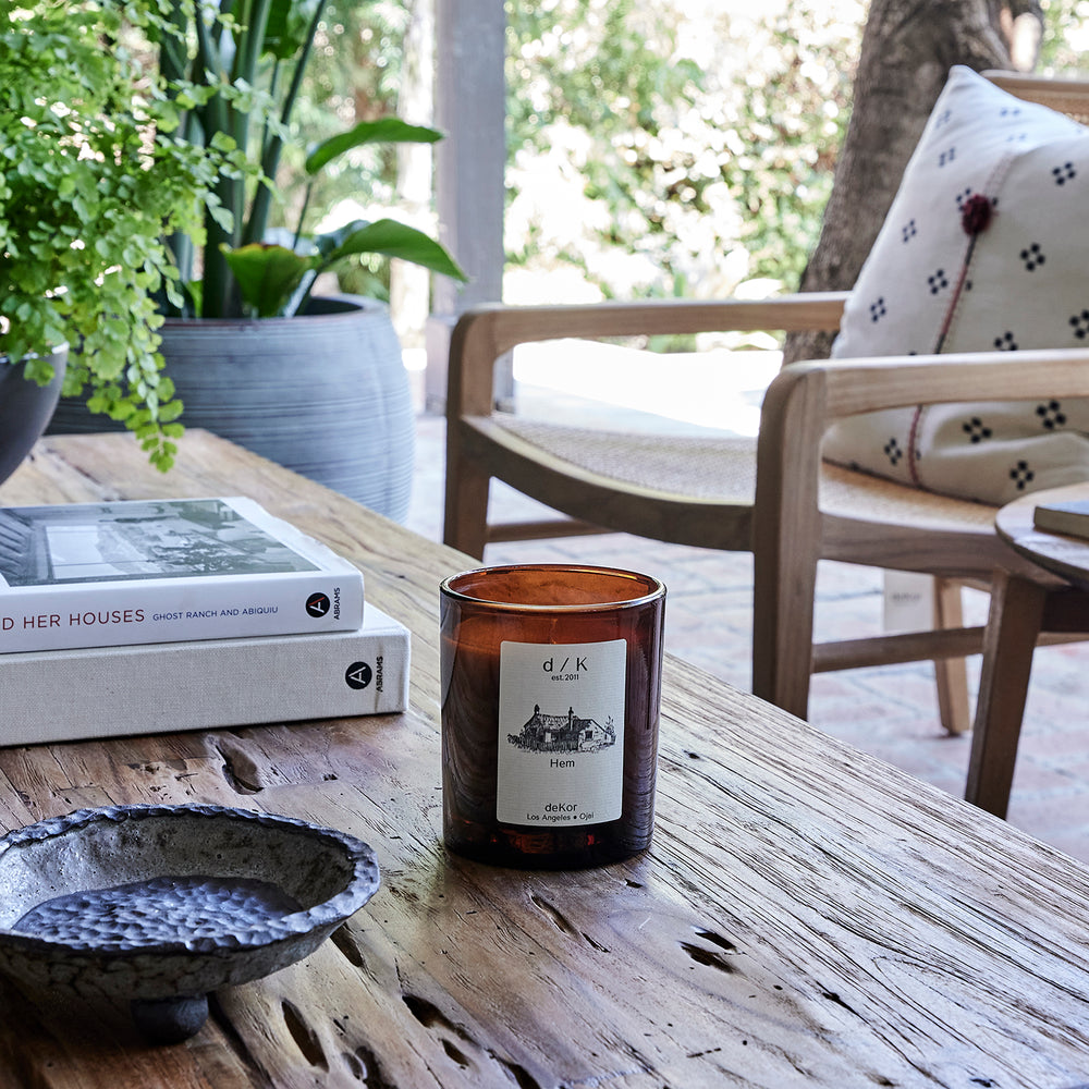 deKor Stuga Organic Candle in an amber color glass jar with a wooden lid