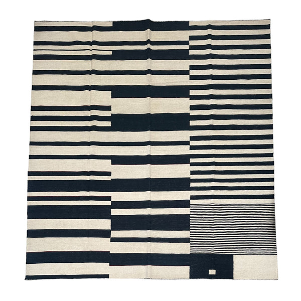 black and cream kilim rug with offset stripes