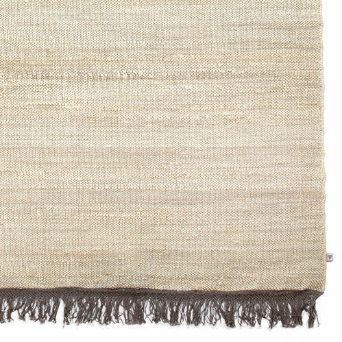 Light beige natural jute area rug with brown fringe
