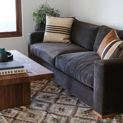Close up detail of Karl sofa with vintage kilim pillows and moroccan geometric rug.