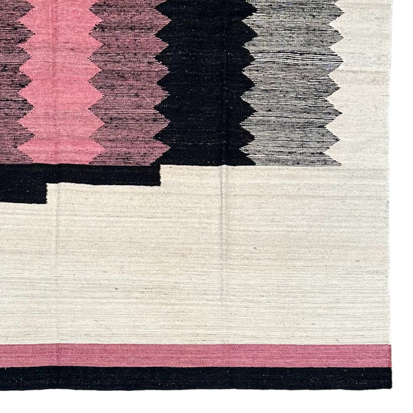 pink black and cream colored flat weave kilim rug