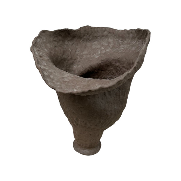 This vessel is a large, handmade ceramic piece with a rough, natural texture, like the surface of a weathered rock. It has an irregular, organic shape, flaring out widely at the top with a slightly uneven, flowing edge. The base of the vessel is narrower, giving it a sturdy yet graceful appearance. The overall texture and shape feel very earthy and tactile.