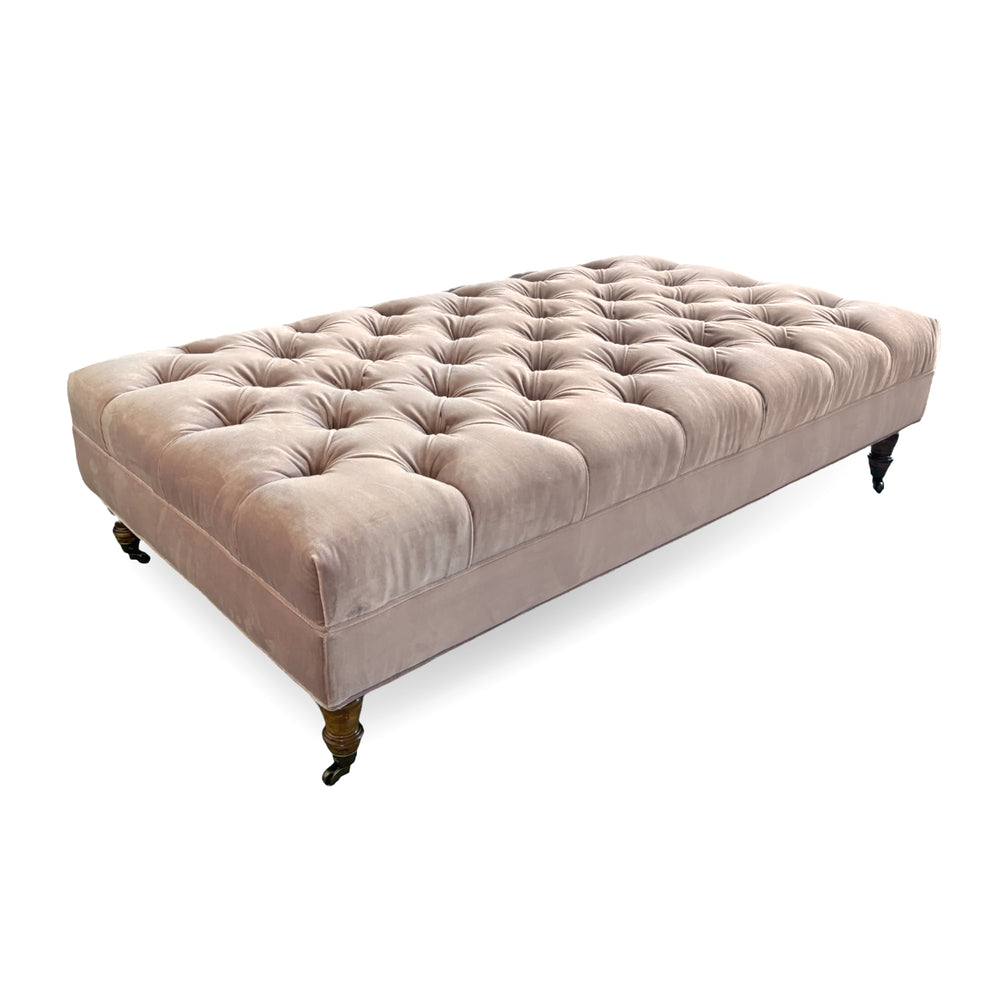Tufted pink velvet ottoman with wood turned legs