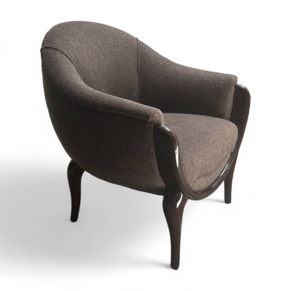 Grey fabric accent chair with rounded frame and walnut legs.