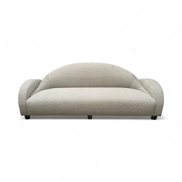 Light gray sofa with a curved back and curved arms. 