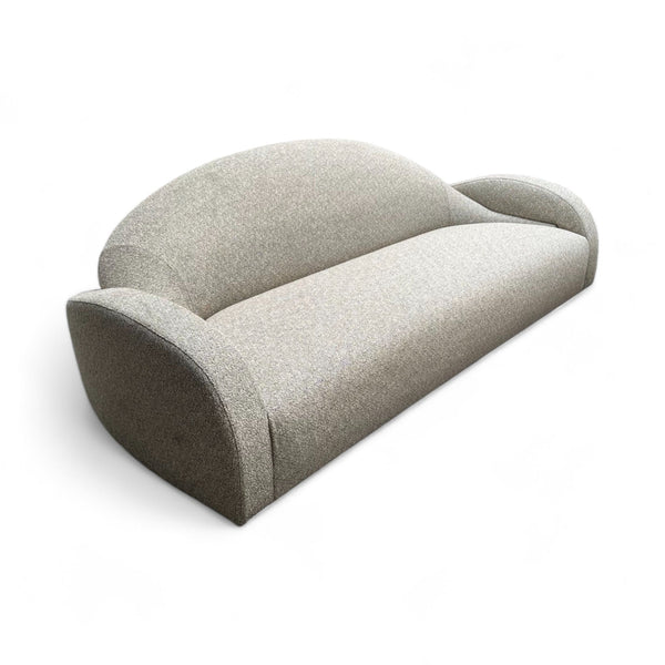 Light gray sofa with a curved back and curved arms. 
