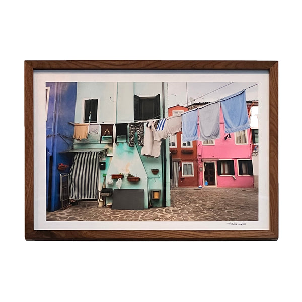 Framed photo print of clothes line and colorful buildings in Burano, Italy. 