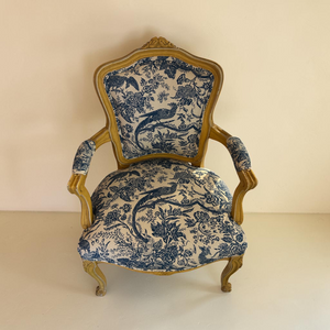deKor vintage armchair featuring a light wood frame and blue and white toile fabric with bird and floral patterns.