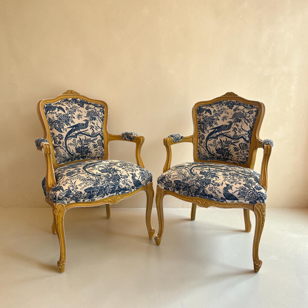 Pair of deKor vintage chairs featuring blue and white toile fabric upholstery and ornate wooden frames