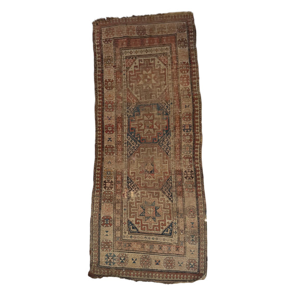 This is a long, rectangular rug with a textured surface that feels slightly worn and soft from age. The pattern is intricate, with raised sections that alternate between geometric shapes and borders. The edges are uneven, and the rug has a slightly rough, tactile quality where the fibers are more faded or frayed. It feels lightweight yet durable, ideal for a narrow space like a hallway.