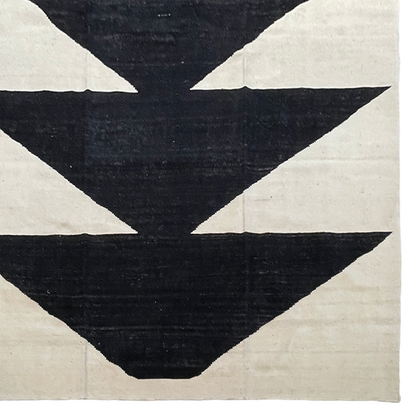 Cream area rug with black geometric design