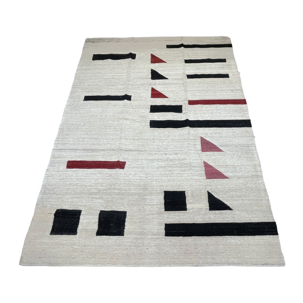 white modern kilim area rug with black pink and red accents