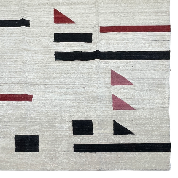 White Kilim rug with pink red and black abstract accents 