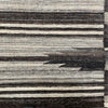 closeup detail of neutral striped kilim area rug