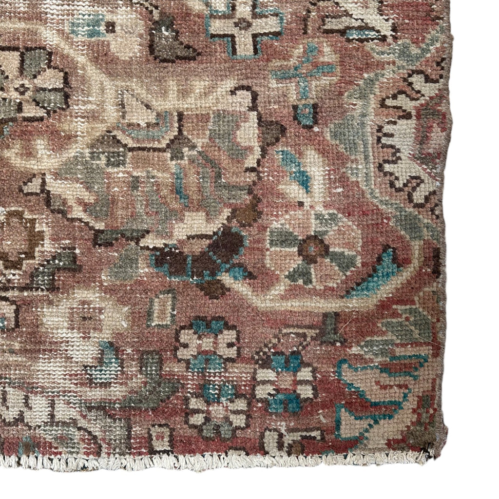 vintage persian rug with brown background and beige and turquoise floral accents