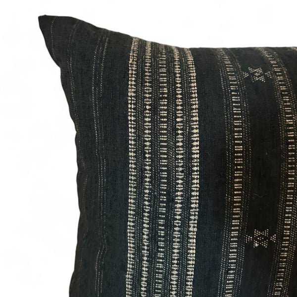 Close up of black & gray vintage fabric pillow with embroidery and tribal print
