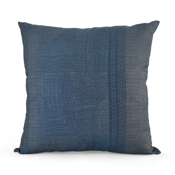 Vintage faded blue fabric pillow with white delicate stitching throughout creating stripes and squares