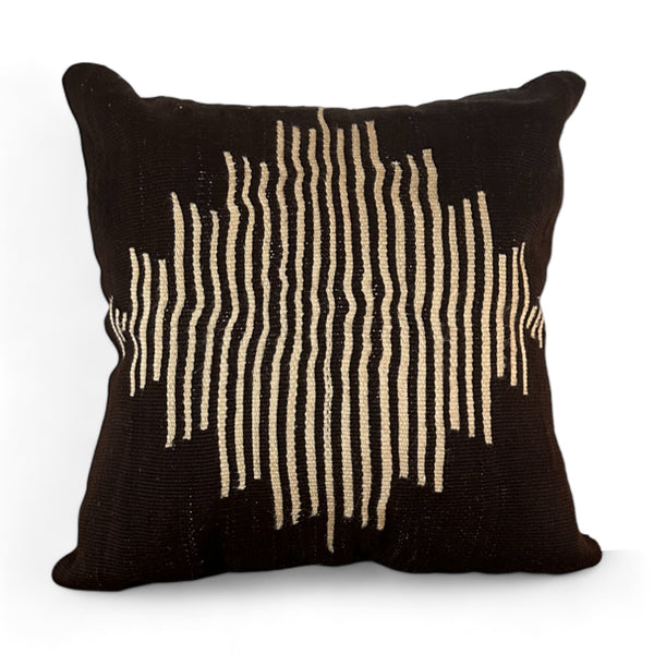 Brown vintage pillow with white stripes in the shape of a diamond