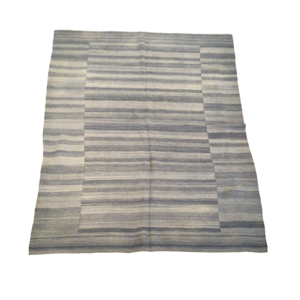 This rug has a smooth texture with horizontal stripes in different widths. The colors are soothing shades of blue, gray, and off-white, giving it a cool, relaxed feel. The stripes are evenly spaced and smooth, with no raised textures or complex designs, making the overall look simple and calming.