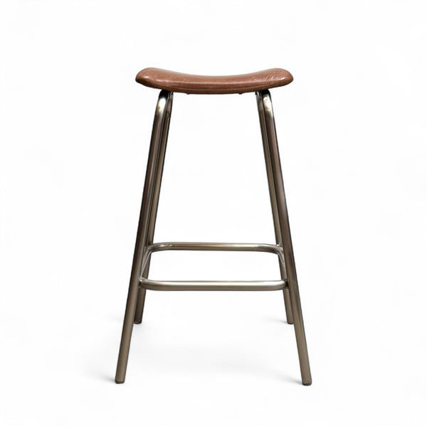 Bar stool with brown leather seat and metal frame on a white background