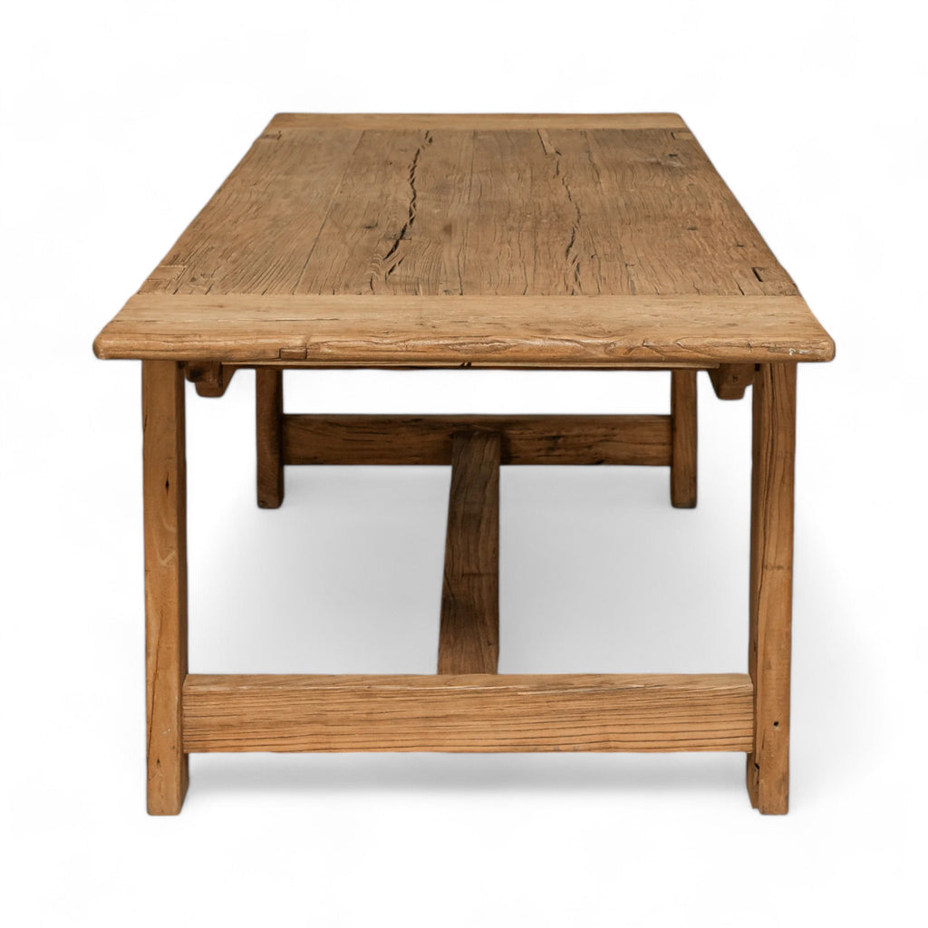 Reclaimed elm wood with a natural finish, this rectangular dining table adds a touch of warmth and character to any space.