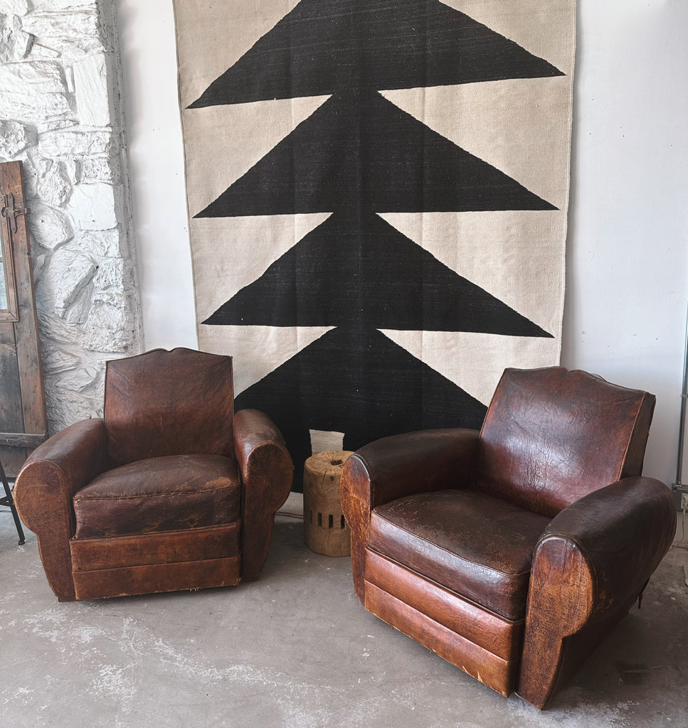 Pair of antique leather club chairs in los angeles design showroom