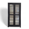 Vintage wooden display cabinet painted black with glass windows and charming black handles. 