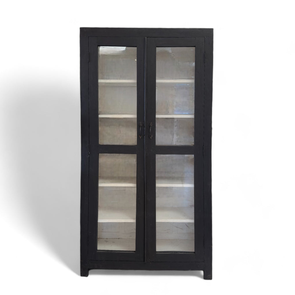 Vintage wooden display cabinet painted black with glass windows and charming black handles. 