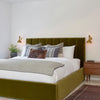 padded velvet headboard platform bed frame in los angeles bedroom with vintage mcm bedside table