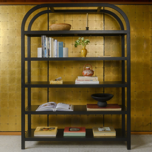 deKor arched frame large bookcase in black oak veneer with five shelves against a gold leaf wall