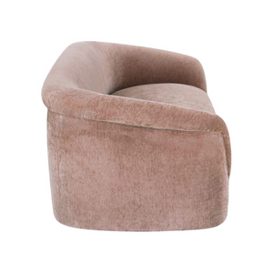 deKor blush velvet-like rolled arm sofa with a curved silhouette and fixed back, side view.