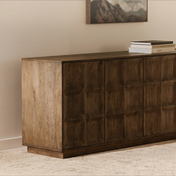 deKor Bowen sideboard in matte sandblast brown solid mango wood with a geometric blocky design and four cabinet doors.