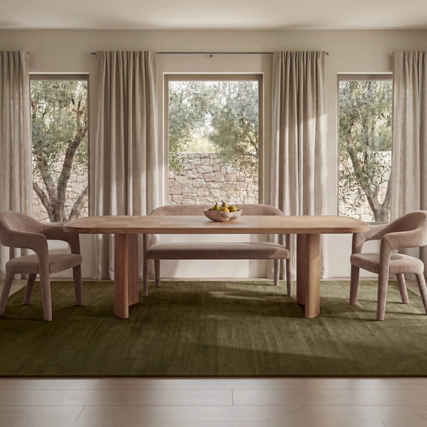 deKor camel polyester barrel back dining bench with iron frame in a bright, modern dining room setting.