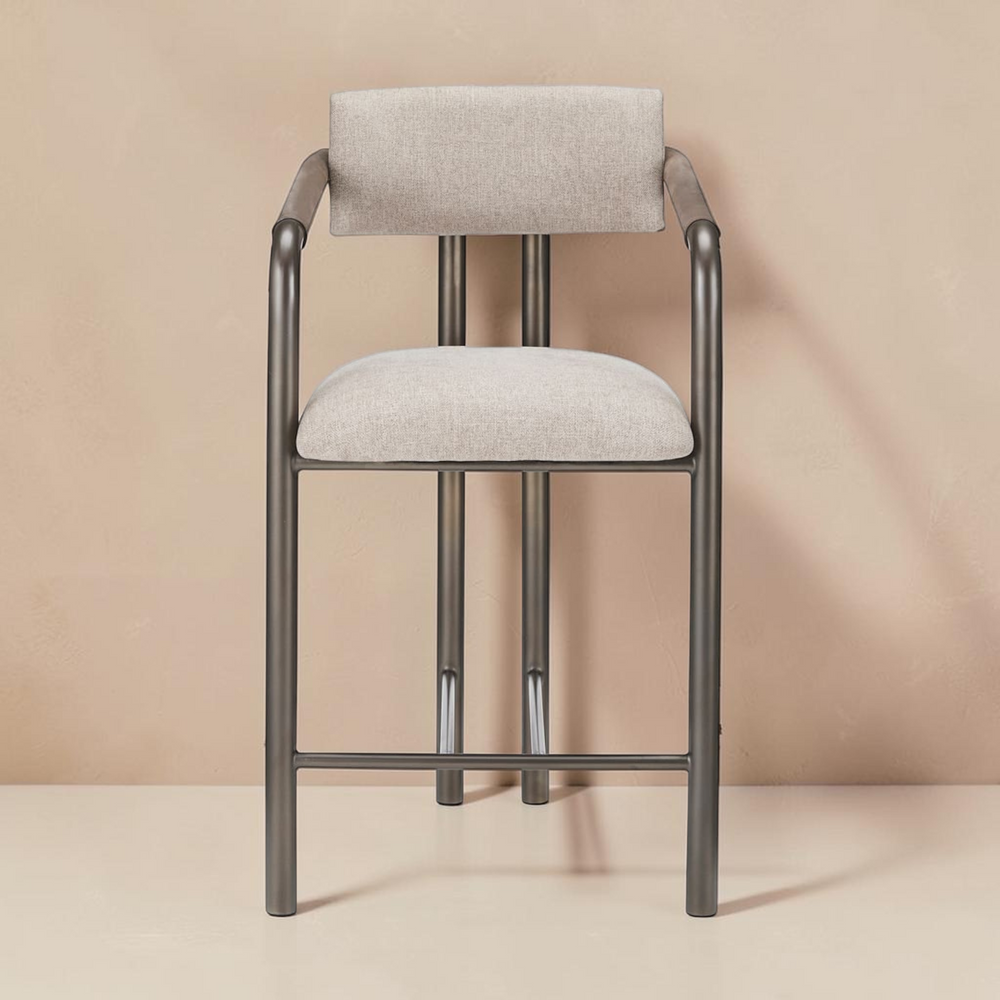 deKor Cassidy counter stool with a brown metal frame and upholstered beige fabric seat and backrest