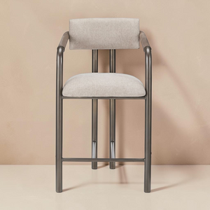 deKor Cassidy counter stool with a brown metal frame and upholstered beige fabric seat and backrest