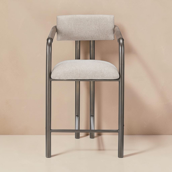 deKor Cassidy counter stool with a brown metal frame and upholstered beige fabric seat and backrest
