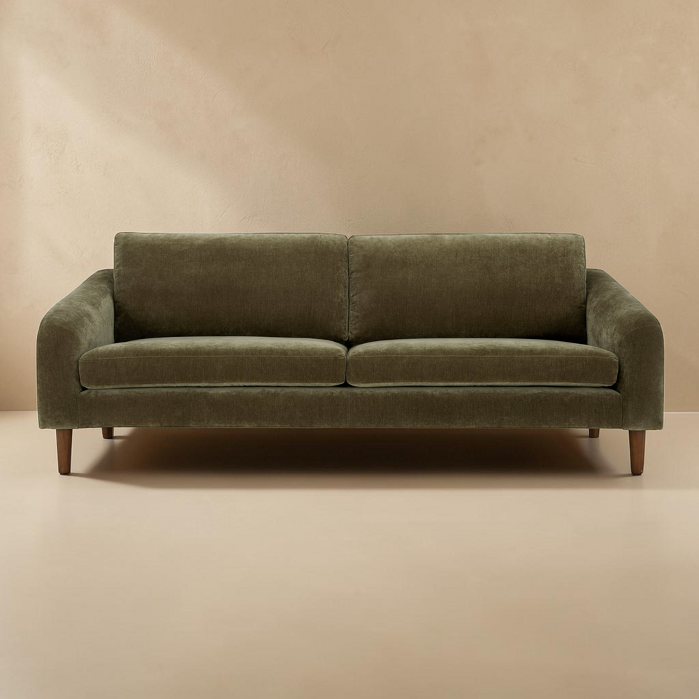 deKor Cedar Green sofa with a transitional frame, soft-touch fabric, and tapered wooden legs in a neutral room.