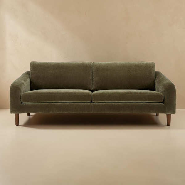 deKor Cedar Green sofa with a transitional frame, soft-touch fabric, and tapered wooden legs in a neutral room.