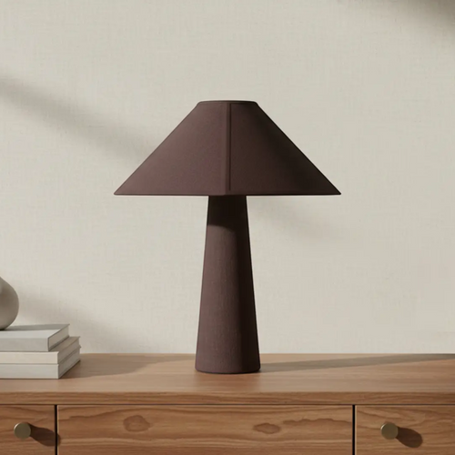 deKor cotton-wrapped table lamp in dark brown with a minimalist geometric silhouette on a wooden console table.