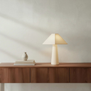 deKor cotton-wrapped table lamp with a minimalist geometric silhouette on a wooden console table.