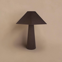 deKor cotton-wrapped table lamp in dark brown with a minimalist geometric silhouette and tactile fabric texture.