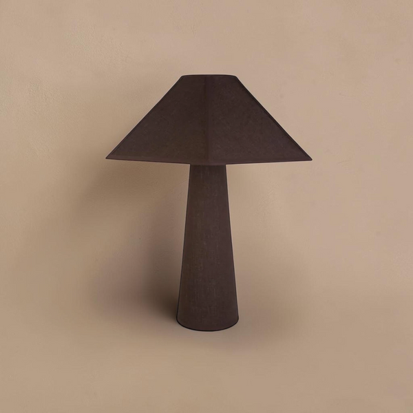 deKor cotton-wrapped table lamp in dark brown with a minimalist geometric silhouette and tactile fabric texture.